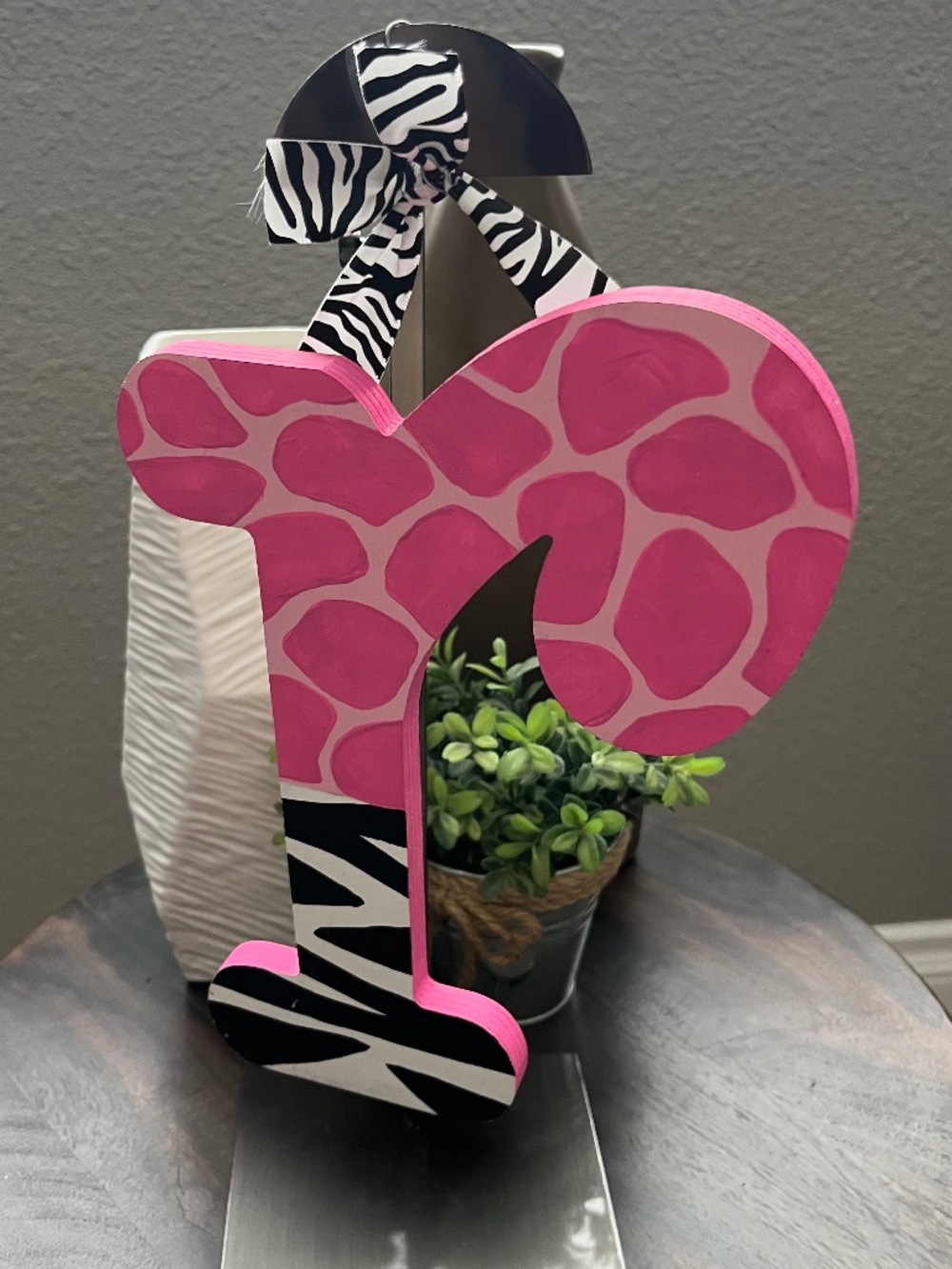 Animal print nursery decor item is a hand-painted wooden wall letter R